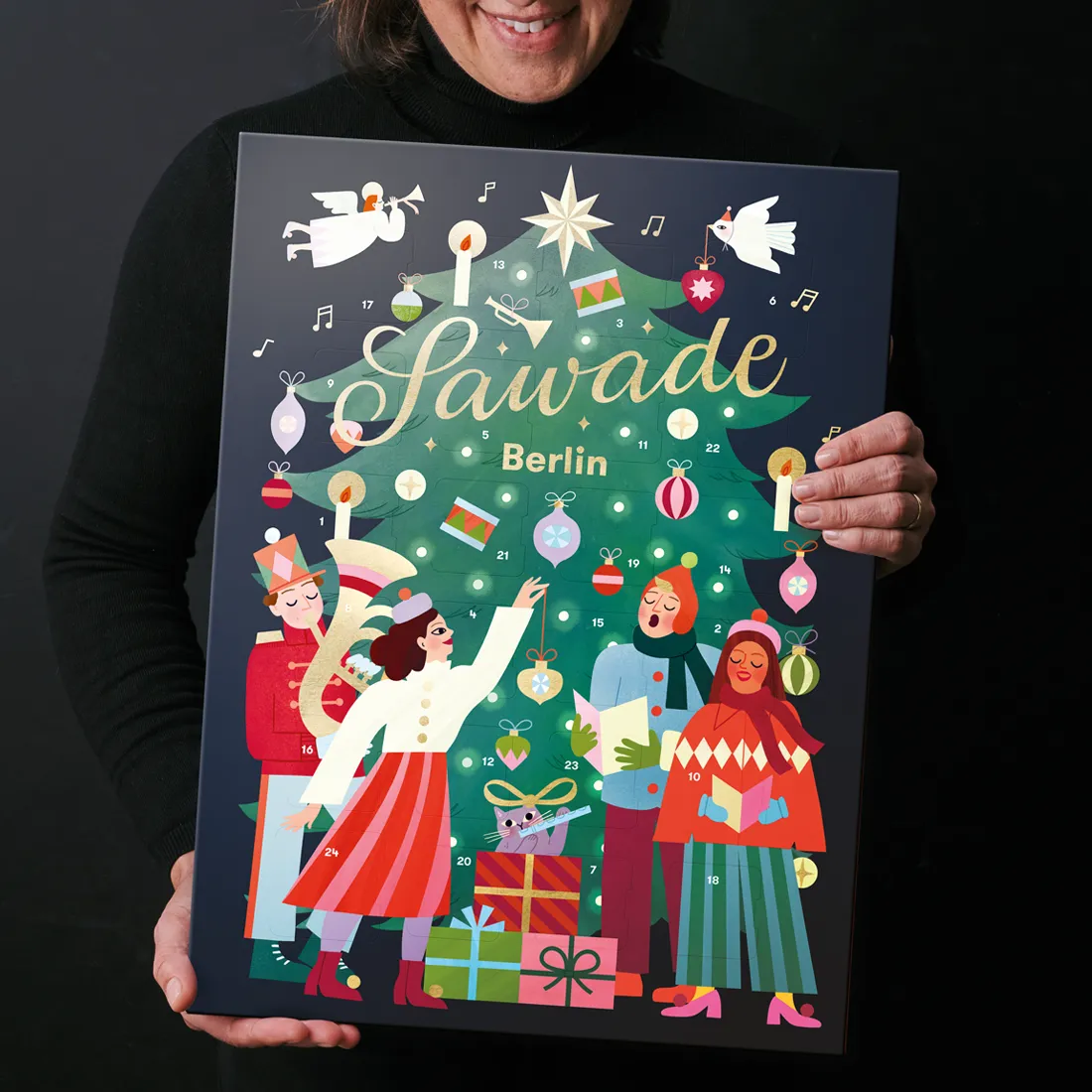 Stimmungsbild: Adventskalender Tannenbaum wird von einer Person lächelnd präsentiert